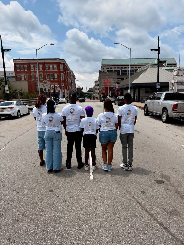 Birthday 2 Remember volunteers wearing organization shirts together in downtown Atlanta.
