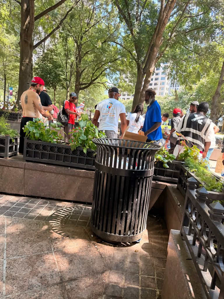 Birthday 2 Remember volunteers serving individuals directly in a downtown Atlanta park.